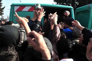 Migrants and refugees receive food as they wait to &hellip;