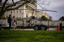 People walk past a gyro copter that was flown onto   the grounds of the U.S. Capitol before it was towed from the west front lawn in   Washington