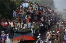 Devotees ride on the roof of a train as they return   to the city after attending the final prayers on the first phase of Bishwa Ijtema   in Dhaka