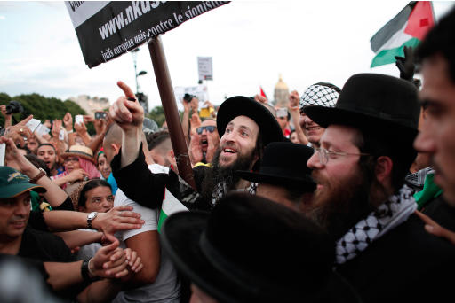 Members of the Ultra-Orthodox Jewish Neturei Karta, a group that opposes Zionism and the Israeli state, protest against the Israeli army's bombings in the Gaza strip in Paris, France, Wednesday, July 23, 2014. Protesters marched Wednesday through Paris against the Israel-Gaza war under the watch of hundreds of police in an authorized demonstration days after two banned protests degenerated into urban violence. (AP Photo/Thibault Camus)