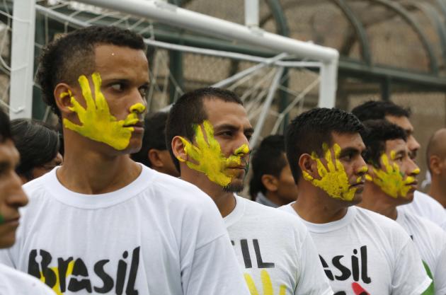 Prisoners participate in the opening ceremony of their own version of the 2014 World Cup at the Castro-Castro prison in Lima