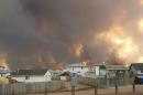 Residents evacuated as fires threaten Canada oil sands town