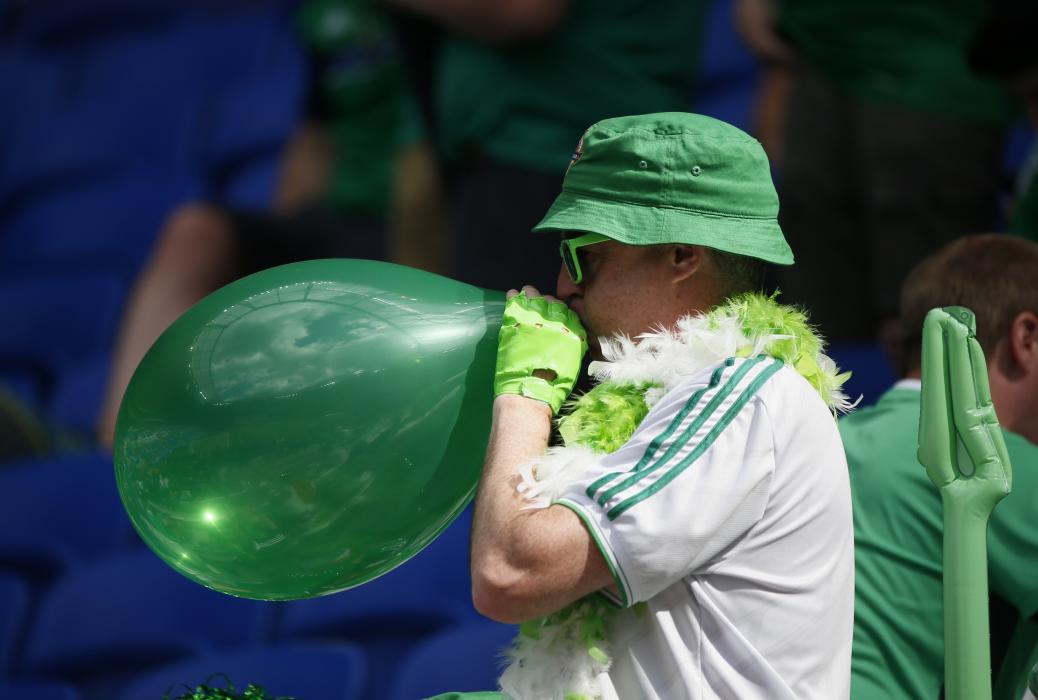 A Northern Ireland fan blows up a balloon before the match