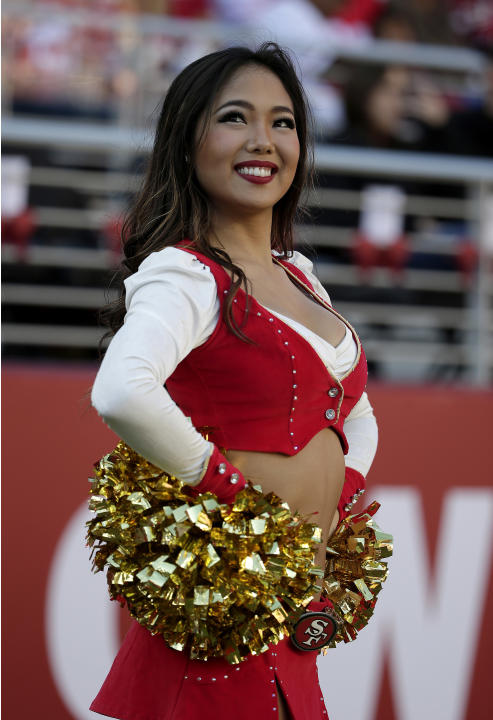A San Francisco 49ers cheerleader smiles during the first quarter of an NFL football game against the St. Louis Rams in Santa Clara, Calif., Sunday, Nov. 2, 2014. (AP Photo/Marcio Jose Sanchez)