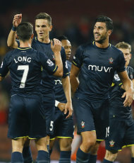 Southampton's Shane Long, left, Florin Gardos, centre, and Graziano Pelle, right, celebrate at the end of the match after winning the English League Cup soccer match between Arsenal and Southampton at Emirates Stadium in London, Tuesday, Sept. 23, 2014. (AP Photo/Kirsty Wigglesworth)