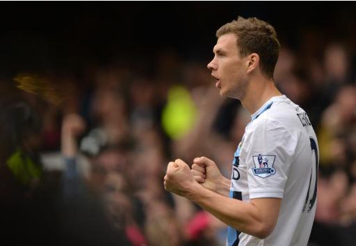 Manchester City's striker Edin Dzeko celebrates scoring his team's second goal during an English Premier League football match against Everton at Goodison Park in Liverpool on May 3, 2014