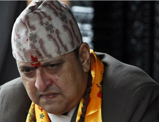FILE - In this July 7, 2011 file photo, Nepal's former King Gyanendra listens to a supporter on his 64th birthday at his residence in Katmandu, Nepal. The last king of Nepal is in stable condition in a hospital after suffering a heart attack, doctors said Sunday, Sept. 21, 2014. (AP Photo/Binod Joshi)