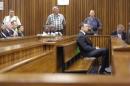 Olympic and Paralympic track star Pistorius sits in   the dock ahead of Judge Masipa's judgement at the North Gauteng High Court in   Pretoria