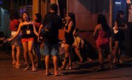 Bar girls wait for customers in the thriving red light district of Angeles City, north of Manila. British banker Rurik Jutting, charged over twin murders in Hong Kong, was a regular in the red-light district