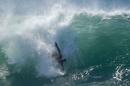 A swimmer catches a wave at "The Wedge" wave break in Newport Beach
