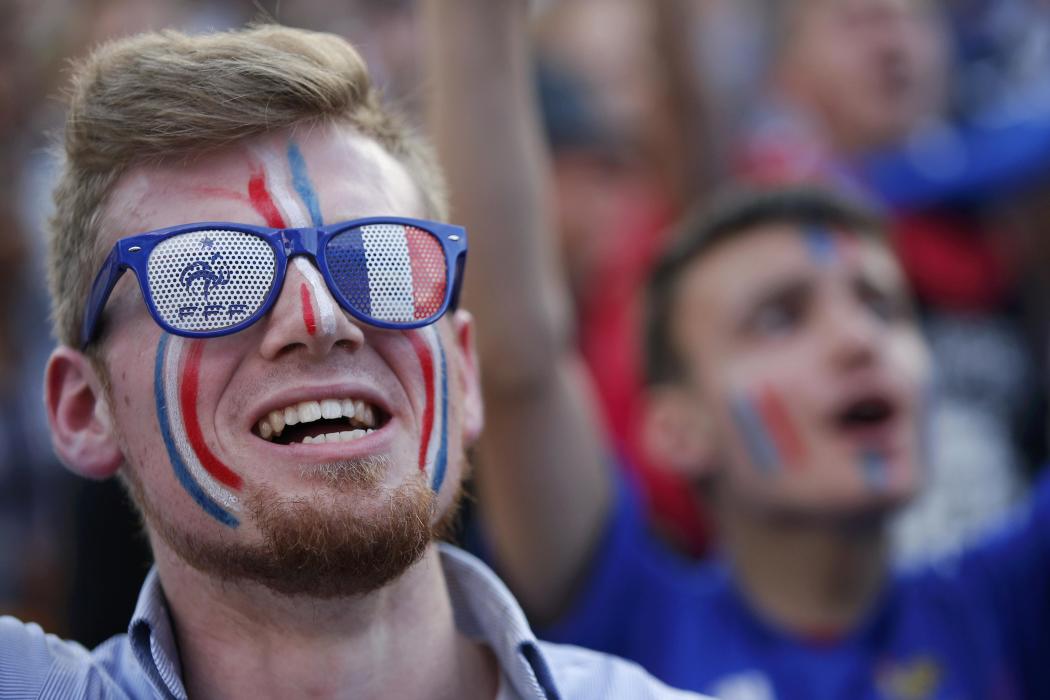 France fans react in the fan zone as they watch the EURO 2016 match in Paris