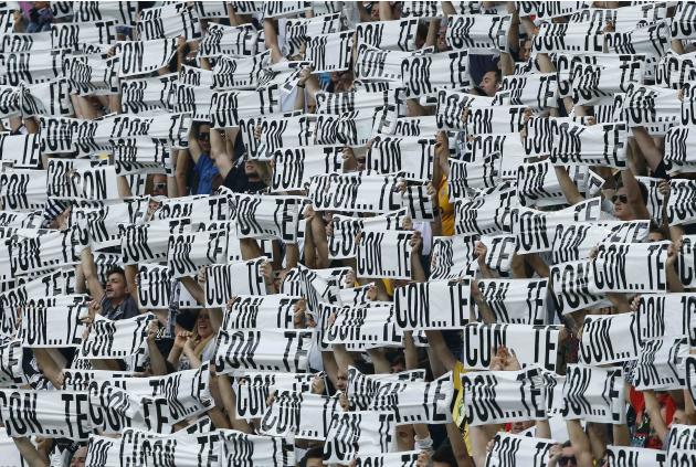 Juventus' supporters hold up banners which read, 