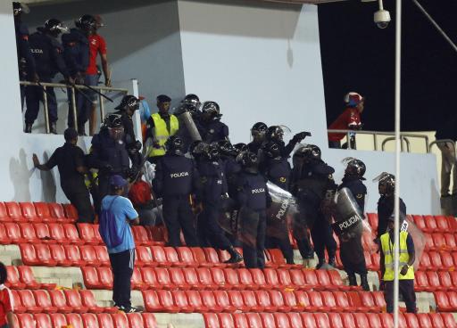 Police instruct Equatorial Guinea fans to move after some of them threw objects during their African Nations Cup semi-final soccer match against Ghana in Malabo