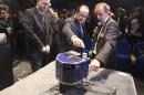 CNES president Le Gall, French President Hollande and astrophysicist Rocard inspect a scale model of Rosetta lander Philae as they visit the Cite des Sciences at La Villette in Paris