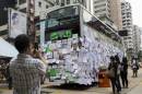 A man takes picture of a bus covered with messages of support at Mongkok shopping district after thousand of protesters blocked the road in Hong Kong