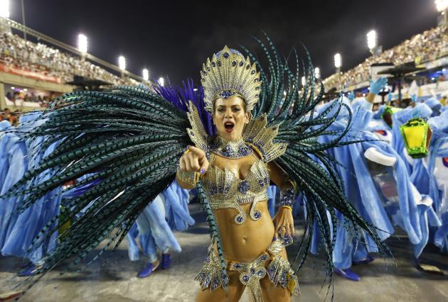 A performer from the Academicos do Grande Rio samba school parades during carnival celebrations at the Sambadrome in Rio de Janeiro, Brazil, early Monday, Feb. 16, 2015. (AP Photo/Leo Correa)