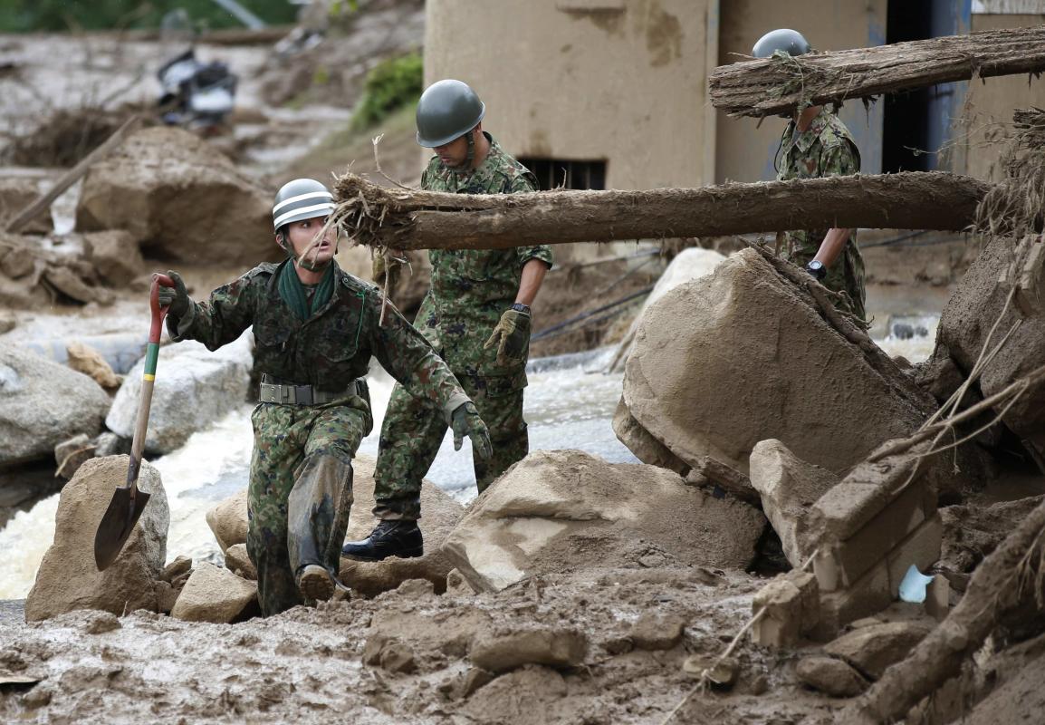 JSDF soldiers search for survivors at a site where a landslide swept through a residential area at Asaminami ward in Hiroshima