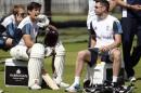 England's captain Cook sits with team-mate Anderson during a training session before Thursday's second cricket test match against India at Lord's cricket ground in London