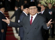 Prabowo Subianto a political rival to Indonesia's seventh President Joko Widodo's gestures as he arrives ahead of Widodo's inauguration at Parliament in Jakarta, Indonesia, Monday, Oct. 20, 2014. (AP Photo/Mark Baker)