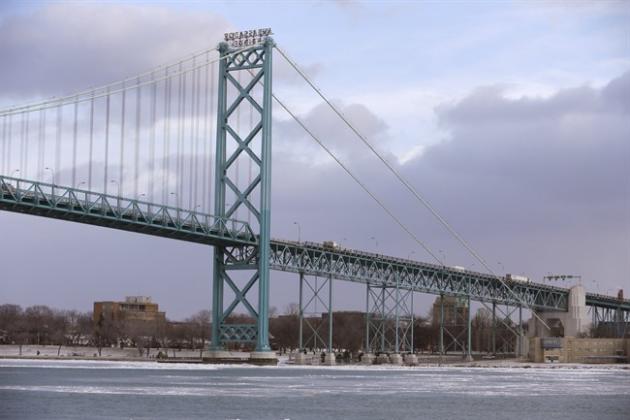 In a photo from Jan. 6, 2015 in Detroit, the Ambassador Bridge leading into Windsor, Ontario is seen from Detroit. The U.S. Department of Homeland Security says the Obama administration and Canada have agreed with Canada for financing a key piece of a planned $2.1 billion bridge connecting Detroit and Windsor, Ontario. The department said Wednesday, Feb. 18, 2015, the agreement involves funding for a toll plaza on the U.S. side of the international crossing. Michigan Sen. Debbie Stabenow released a statement saying the agreement "is a critical step forward" for the project, long stymied by opposition from owners of the nearby Ambassador Bridge who seek to add a span of their own across the Detroit River. (AP Photo/Carlos Osorio)