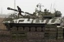 Member of self-proclaimed Donetsk People's   Republic forces walks on top of self-propelled artillery gun during tactical   training exercises in Donetsk region