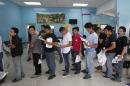 Deportees line up to fill immigration forms at the   Care Center for Returning Migrants (CAMR) after arriving on an immigration flight   from the U.S., at the international airport in San Pedro Sula