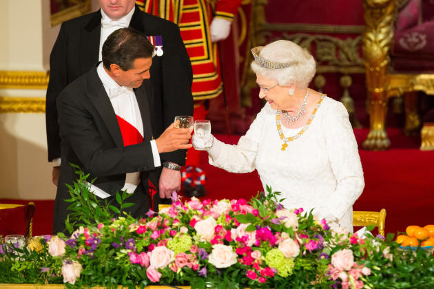 President of Mexico, Enrique Pena Nieto, and Queen Elizabeth II perform a toast whilst attending a state banquet at Buckingham Palace, London, during day one of the President of Mexico's state visit t