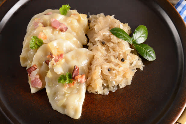 Pierogi are dumplings of unleavened dough which are boiled, stuffed with potato, sauerkraut, ground meat, cheese, or fruit that are then they are baked or fried, usually in butter with onions, and ser