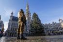 A Belgian soldier patrols in Brussels' Grand   Place as police searched the area during a continued high level of security   following the recent deadly Paris attacks
