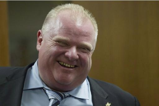 Toronto Mayor Rob Ford (right) shares a laugh with one of his staff members outside his office at city hall in Toronto on Wednesday, March 19, 2014. A media report is making fresh claims about Rob Ford, with accusations the Toronto mayor was driving while under the influence and making racist and sexual comments. THE CANADIAN PRESS/Chris Young