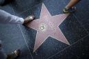 People walk over Bill Cosby's star of the   Hollywood Walk of Fame in Los Angeles