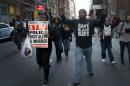 Protesters march with their hands up during a   demonstration against police violence in Manhattan