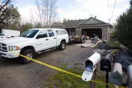 Authorities investigate a crime scene at a house in Pleasant Grove Utah, Sunday, April 13, 2014. According to the Pleasant Grove Police Department, seven dead infants were found in the former home of Megan Huntsman, 39. Huntsman was booked into jail on six counts of murder. (AP Photo/Daily Herald, Mark Johnston)