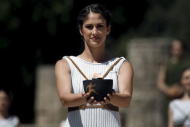 A priestess carries the Olympic Flame during the dress rehearsal for the Olympic flame lighting ceremony for the Rio 2016 Olympic Games at the site of ancient Olympia in Greece, April 20, 2016. REUTERS/Yannis Behrakis