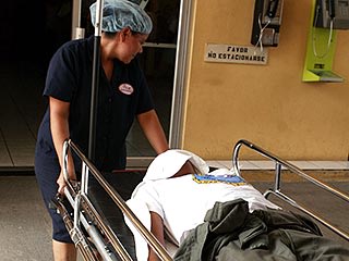 Man on stretcher, El Salvador copyright Luis Romero/Associated Press