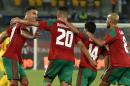 L'attaquant Aziz Bouhaddouz (2g) est congratulé par ses coéquipiers après avoir ouvert le score pour le Maroc face au Togo lors de la CAN, le 20 janvier 201...<br /><br />Source : <a href=