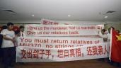 Chinese relatives of passengers from flight MH370 display banners and the Chinese flag (far right) at a hotel in Subang Jaya on March 30, 2014