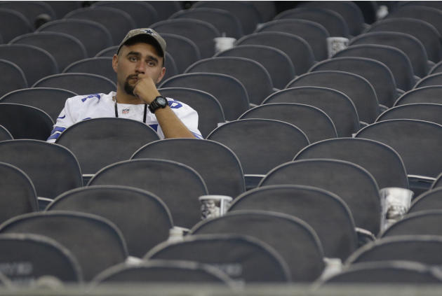 A Dallas Cowboys fan sits in the stands afar the NFL football game against San Francisco 49ers Sunday, Sept. 7, 2014, in Arlington, Texas. (AP Photo/LM Otero)