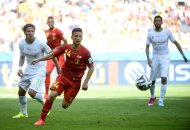 Algeria's Mehdi Mostefa (L) and Belgium's forward Dries Mertens (C) fight for the ball during their Group H match, at Mineirao Stadium in Belo Horizonte, during the FIFA World Cup, on June 17, 2014