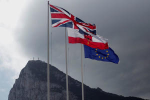 Union Jack, the Gibraltarian flag and the EU flag are seen flying, at the border of Gibraltar with Spain