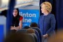 U.S. Democratic presidential nominee Hillary Clinton   talks to staff members, including aide Huma Abedin, onboard her campaign plane in   White Plains