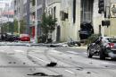 A Hollywood street is closed during an investigation after a car crash involving a Tesla left half the remains wedged between two walls at Congregation Kol Ami synagogue, in West Hollywood, Calif., Friday, July 4, 2014. Authorities said several people were injured after a high-speed chase involving what was reported as a stolen Tesla. (AP Photo/Richard Vogel)