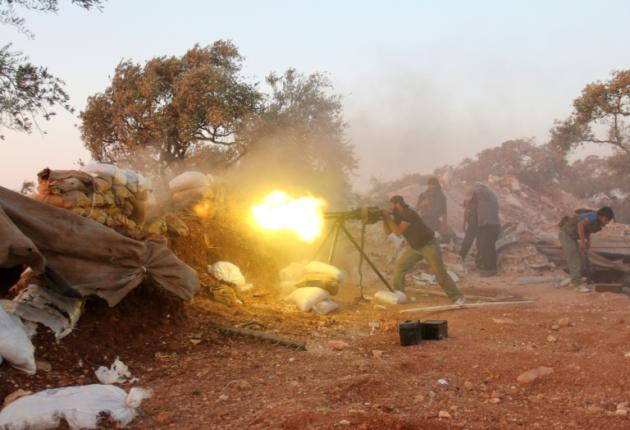 A rebel fighter fires a heavy machine gun during clashes with government forces and pro-regime shabiha militiamen on the outskirts of Syria's northwestern Idlib province on September 18, 2015