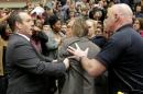 Photographer Christopher Morris is removed by   security officials as U.S. Republican presidential candidate Donald Trump speaks   during a campaign event in Radford