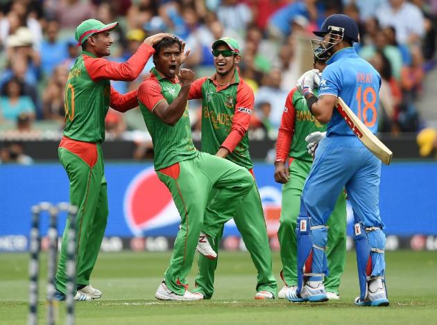 Bangladesh’s Rubel Hossain, second left, celebrates with teammate Mahmudullah, left, and Nasir Hossain after taking the wicket of India's Virat Kohli, right, during their Cricket World Cup quarter