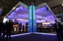 Visitors walk past the Qualcomm stand at the Mobile   World Congress in Barcelona