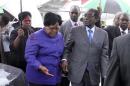 Zimbabwean President Robert Mugabe is greeted by Vice President Joice Mujuru as he returns home to Harare