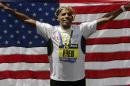 Meb Keflezighi, of San Diego, Calif., celebrates his victory with an American flag after the 118th Boston Marathon Monday, April 21, 2014 in Boston. (AP Photo/Charles Krupa)