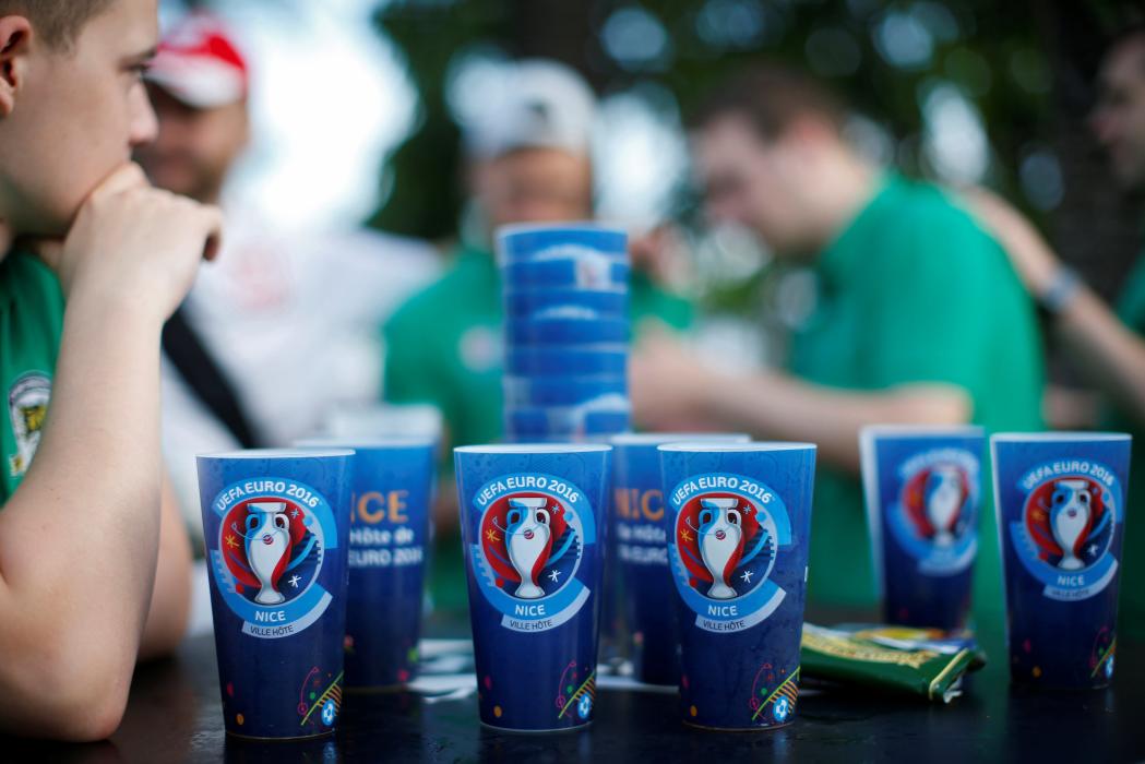 Northern Ireland soccer fans gather near beer cups at the fan zone in Nice