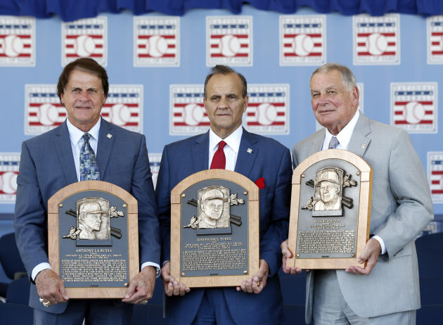 National Baseball Hall of Fame inductees, from left to right, Tony La Russa, Joe Torre and Bobby Cox hold their plaques after an induction ceremony at the Clark Sports Center on Sunday, July 27, 2014,